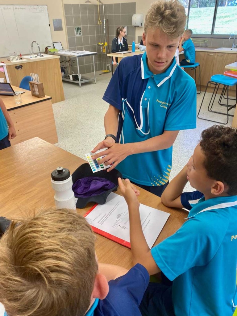 Kyan (Senior) showing Lincoln and Luca how to read the PH levels in the water.